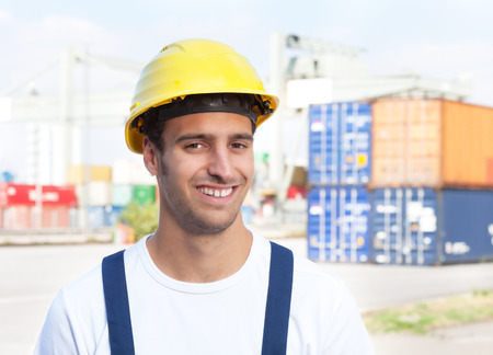 Docker laughing at camera on a seaport