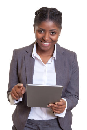 Laughing african businesswoman working with tablet computerの写真素材