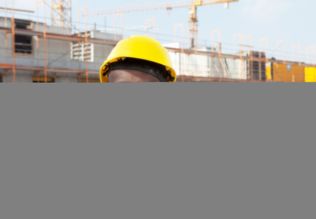 Laughing african american construction worker at building site