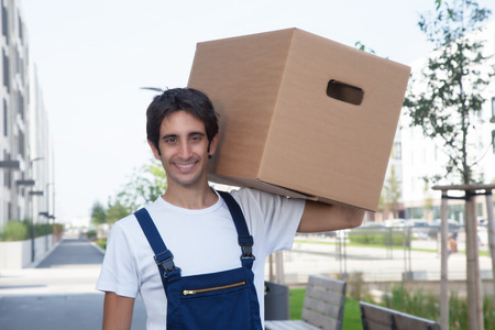 Laughing hispanic removal man with boxの写真素材
