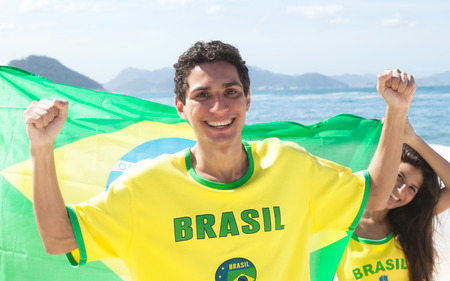 Brazilian sport fans with jersey and flagの写真素材