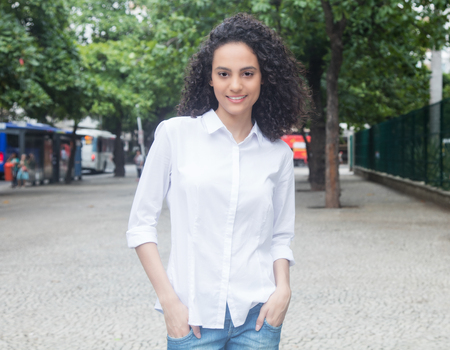 Young caribbean woman with curly hair walking in a parkの写真素材