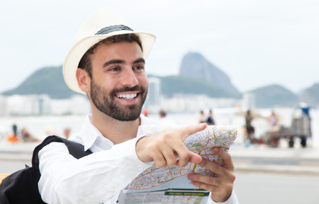 Pointing tourist with map at Rio de Janeiroの写真素材