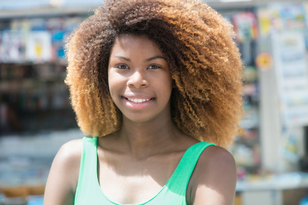 Beautiful african american girl with amazing hairstyle in the cityの写真素材
