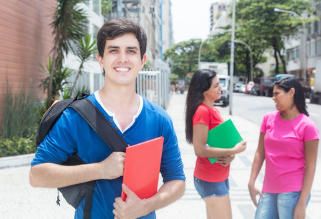 Laughing caucasian male student with friendsの写真素材