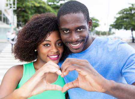 African american love couple showing heartの写真素材