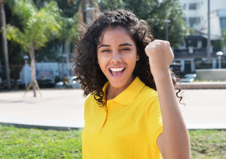 Cheering latin american girl with long dark hairの写真素材