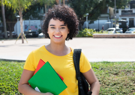Laughing caucasian female student  with curly hair looking at cameraの写真素材