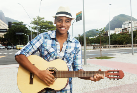 Street musician with playing guitar in the cityの写真素材