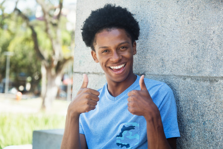 African young adult man showing both thumbs upの写真素材