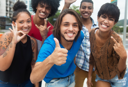 Group of international hipster young adults showing thumbの写真素材