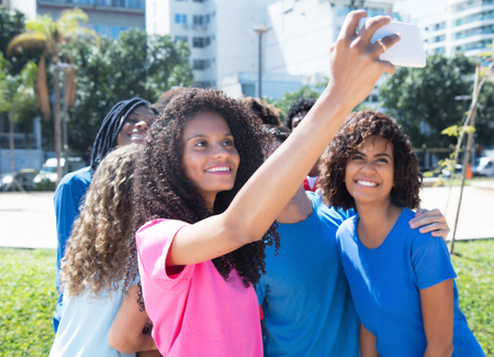 Large group of laughing man and woman taking selfieの写真素材