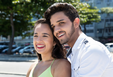 Young caucasian love couple dreaming outdoor in the city in the summerの写真素材