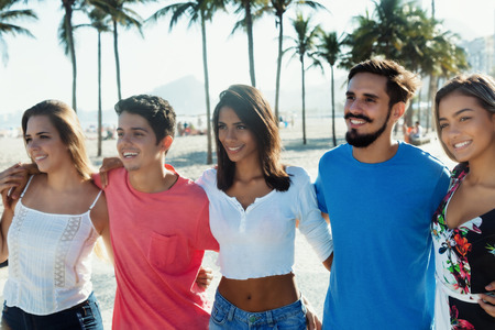 Group of friends arm in arm outdoor in the city in the summerの写真素材