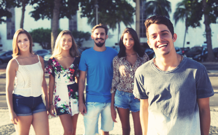 Handsome caucasian man with latin hipster group outdoor in the city in the summerの写真素材