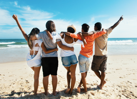 Group of cheering young adults at beach outdoor in the summerの写真素材