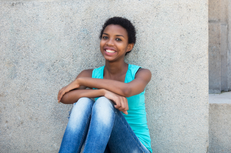 Relaxing african american woman with short hair outdoor in the summerの写真素材