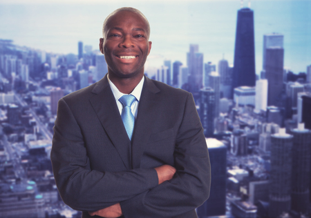 Successful african american businessman with skyline with skyline of city in backgroundの写真素材