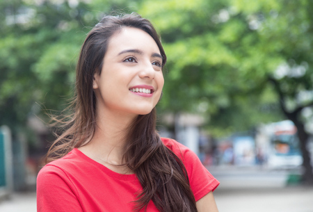 Beautiful woman in a red shirt outdoor in a parkのeditorial素材