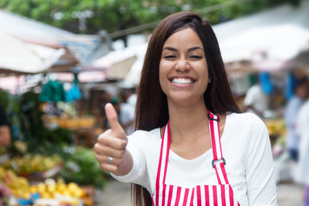 Native latin american saleswoman at farmers marketの写真素材