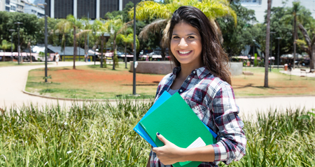 Beautiful caucasian female student laughing at cameraの写真素材
