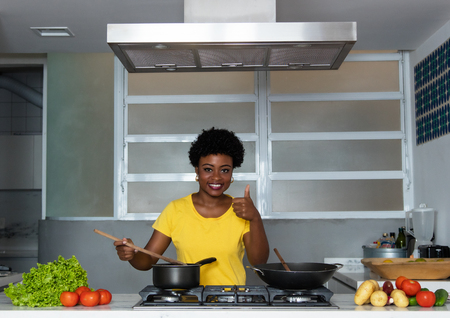 African american woman cooking at kitchenの写真素材