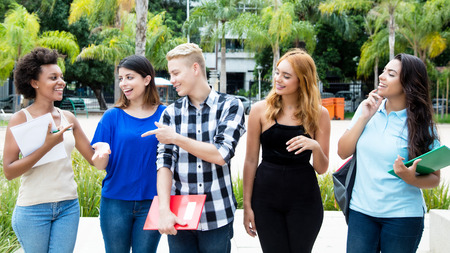 Group of international students walking on campus of university
