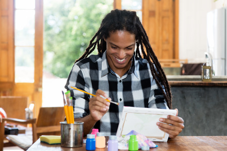 Happy male artist painting at atelierの写真素材