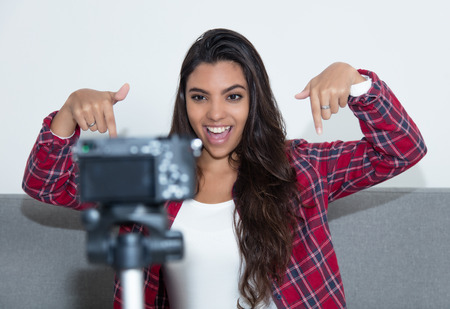 Posing latin american influencer girl recording video blogの写真素材