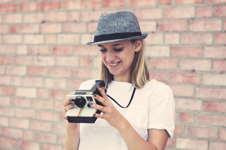 Hipster girl with retro photo cameraの写真素材