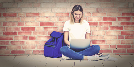 Blond german female student learning at computerの写真素材