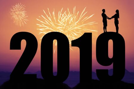 Fireworks and new year 2019 silhouette with couple as symbol for love and weddingの写真素材