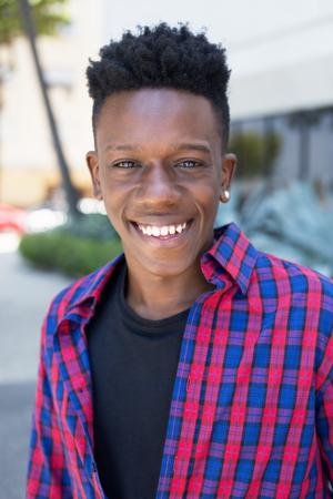Portrait of laughing african american man outdoor in the city