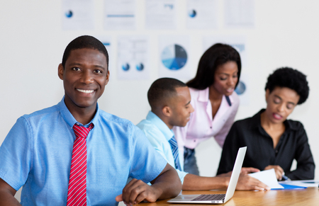 African american businessman with business team at officeの写真素材
