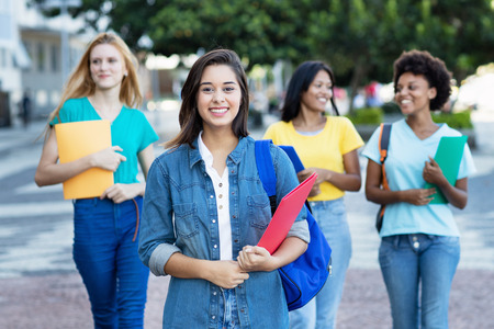 Young spanish female student with group of womenの写真素材