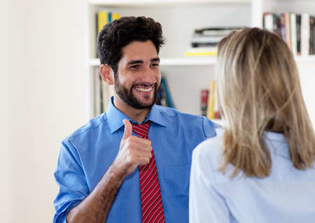 Handsome mexican businessman talking with businesswomanの写真素材