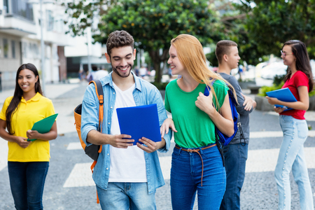 English female student and spanish guy with group of mutliethnic studentsの写真素材