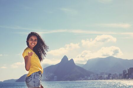 Brazilian woman with curly long hair at Ipanema beach at Rio de Janeiroの写真素材