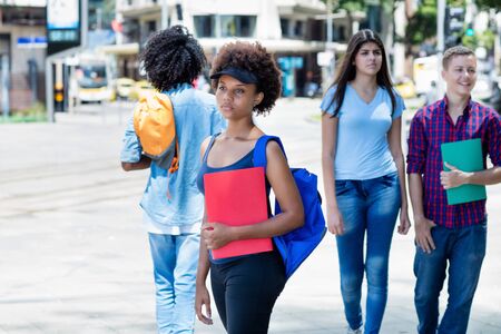 African american female student waiting for busの写真素材