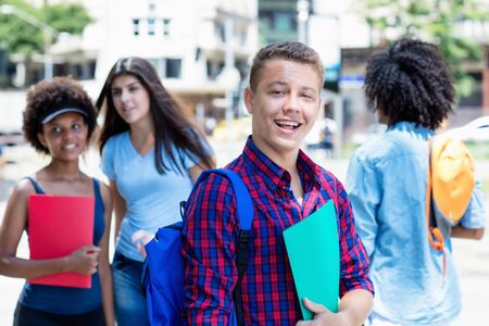 Laughing brazilian male student with group of studentsの写真素材