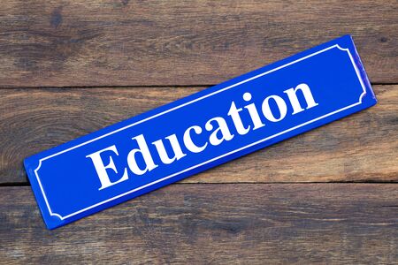 Education street sign on wooden backgroundの写真素材