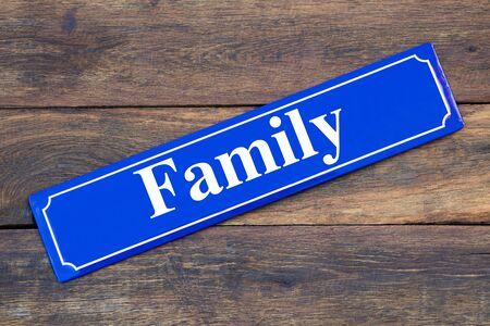 Family street sign on wooden backgroundの写真素材