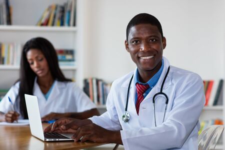 Handsome african american doctor with nurseの写真素材