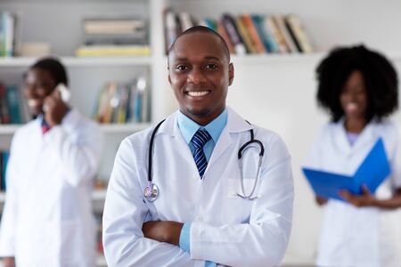 African american mature doctor with medical teamの写真素材