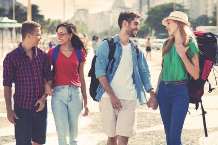 Group of american backpacker and tourists couple walking in the cityの写真素材