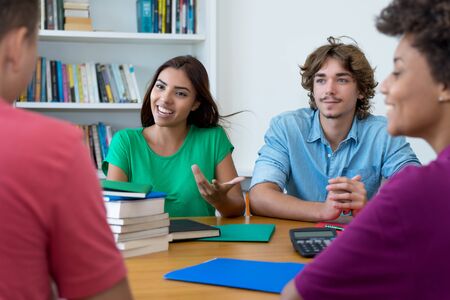 Laughing group of multiracial students preparing for exam