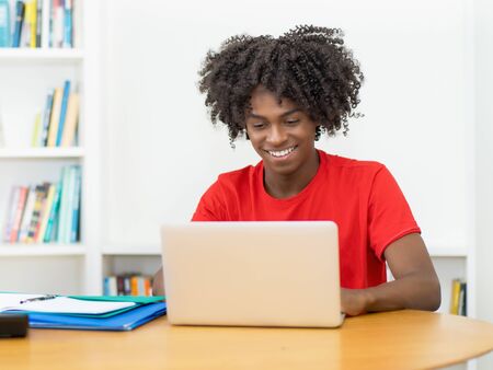 Learning african american male student in quarantine at computerの写真素材