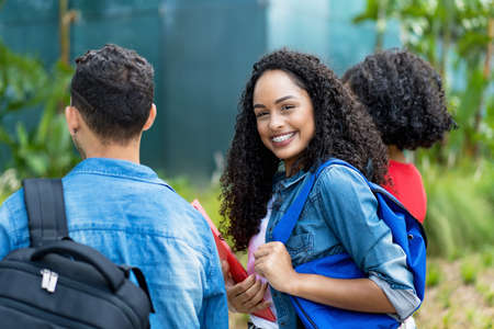 Young adult female student with retainer and group of friendsの写真素材