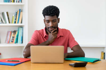 Video call of afro american male student at computerの写真素材