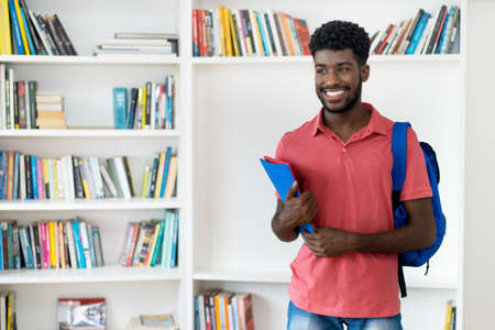 Young afro american male student with backpack and copy spaceの写真素材
